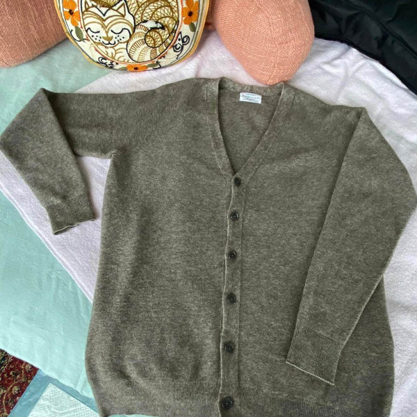 A wool sweater laid flat to dry, the care that makes a capsule staple last